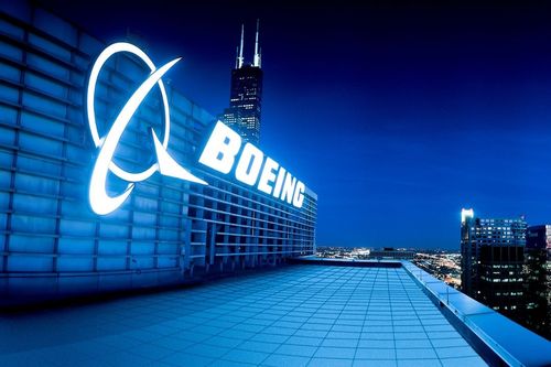 Image shows the outside of a Boeing manufacturing plant.
