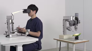 Sony worker uses a prototype of the microsurgery assistance robot