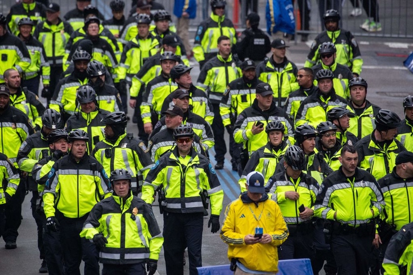 Police officers walk near the finish line during the 127th Boston Marathon.