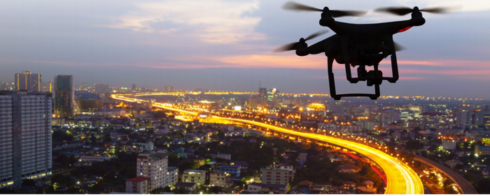 Image shows a drone over a city.