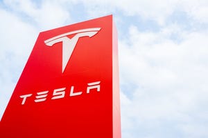 The Tesla logo is displayed at a Tesla dealership on April 15, 2024 in Austin, Texas.