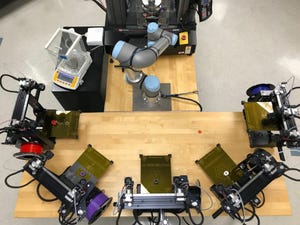 The system contains five printers, a six-axis robotic arm, a scale and a universal testing machine