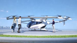 Two passengers walking up to a SkyDrive personal air vehicle before boarding for a flight. 