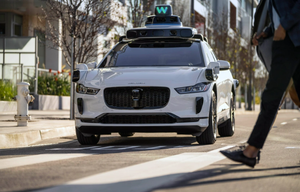 A Waymo self-driving taxi on a road.