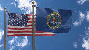 FBI and US flags flying on masts