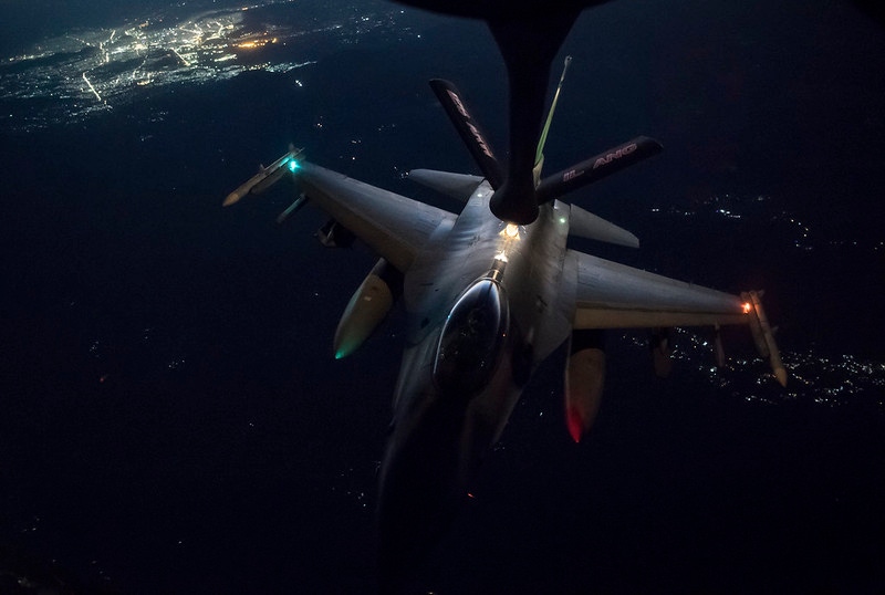 A U.S. Air Force F-16 Fighting Falcon being refueled after dark.  