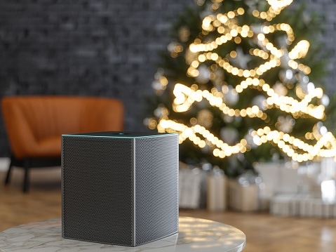 Image shows a smart speaker near a Christmas tree.