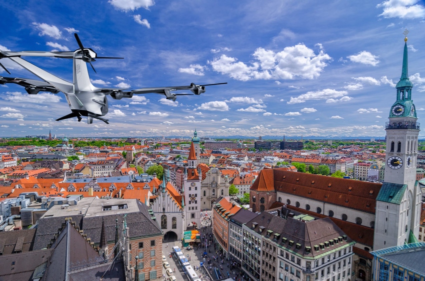 Image shows Elevated view over Munich and the Marienplatz with the St. Peters church on the right, the Heiliggeist church and