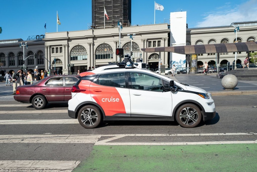 GM Cruise's self-driving taxi drives in front of the Ferry Building on the Embarcedero, San Francisco, California in August 2023.