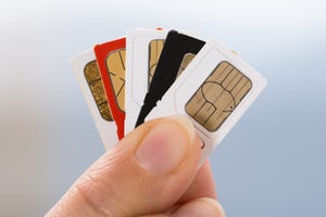 Image of fingers holding SIM cards