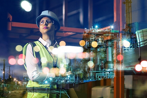 Female worker inside a factory. Female worker inside a factory.