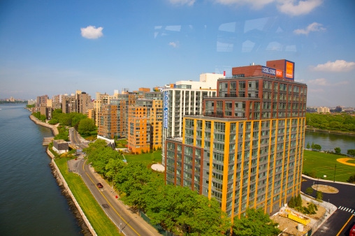 Image shows an aerial view of East River and new residential buildings on Roosevelt Island, looking north, from Roosevelt Isl