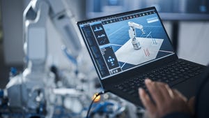 Engineer controls a robotic arm on a tablet