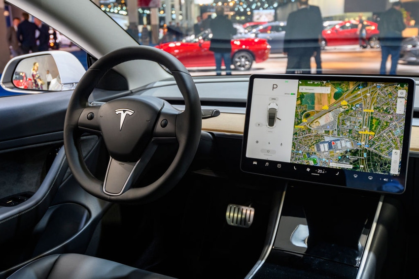 Tesla Model 3 compact full electric car interior with a large touch screen on the dashboard on display at Brussels Expo in 2020.