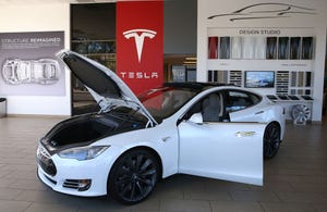 Image shows A Tesla Model S car is displayed at a Tesla showroom on November 5, 2013 in Palo Alto, California.