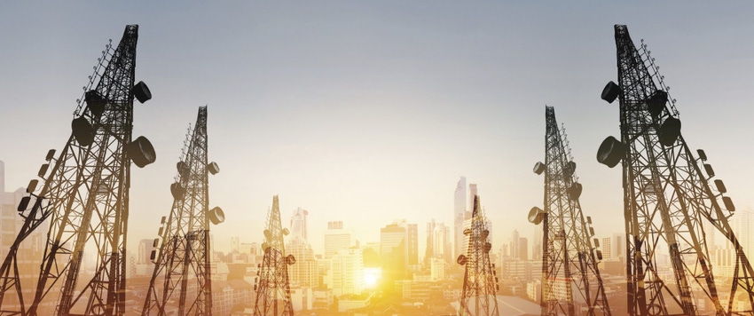 Image of telecommunications towers with antennas and cityscape