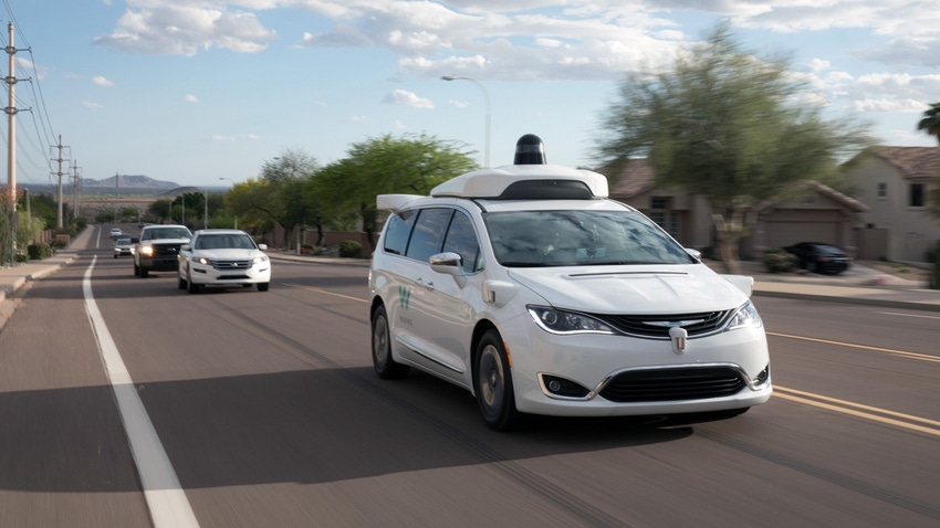 Image shows a Waymo self-driving vehicle on the road.