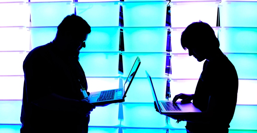 Silhouette of two laptop users
