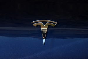 Tesla logo on a blue background.