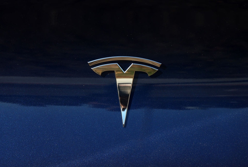 Tesla logo on a blue background.