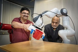 Engineers demonstrate the robot's ability to pick up a cup