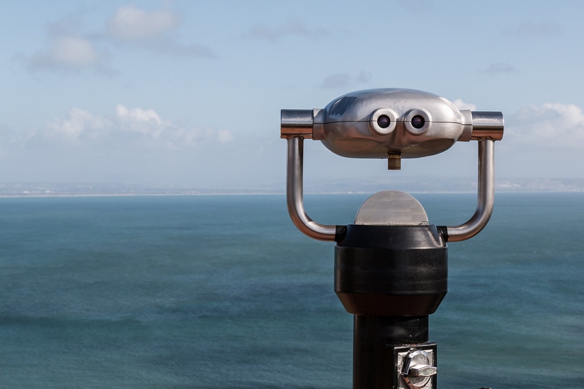 Sightseeing binoculars overlooking the ocean from a high vantage point