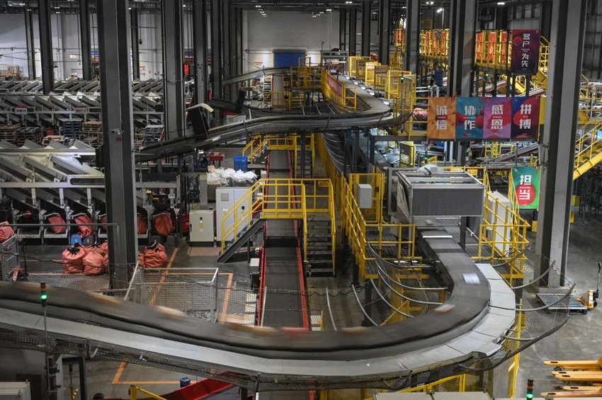 Image shows Packages for delivery are seen on automated conveyor belts