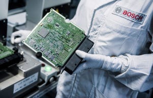 Image of Bosch worker holding a microprocessor