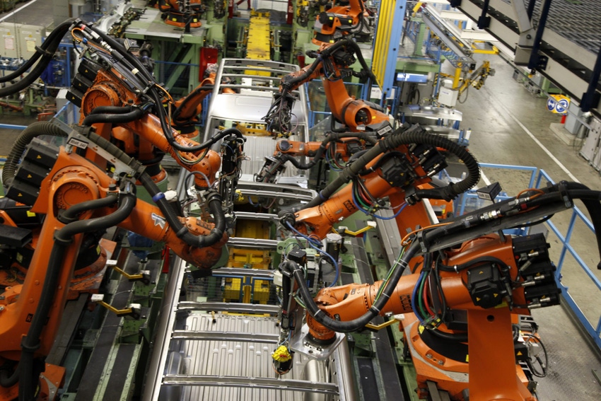 Image shows welding robots at a car factory
