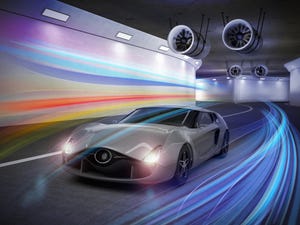 Image shows a metallic gray sports car in the tunnel