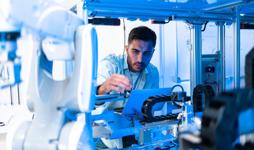 Image shows a team of engineers are conducting an experiment with robots.Close Up of a Futuristic Prosthetic Robot Arm Being 