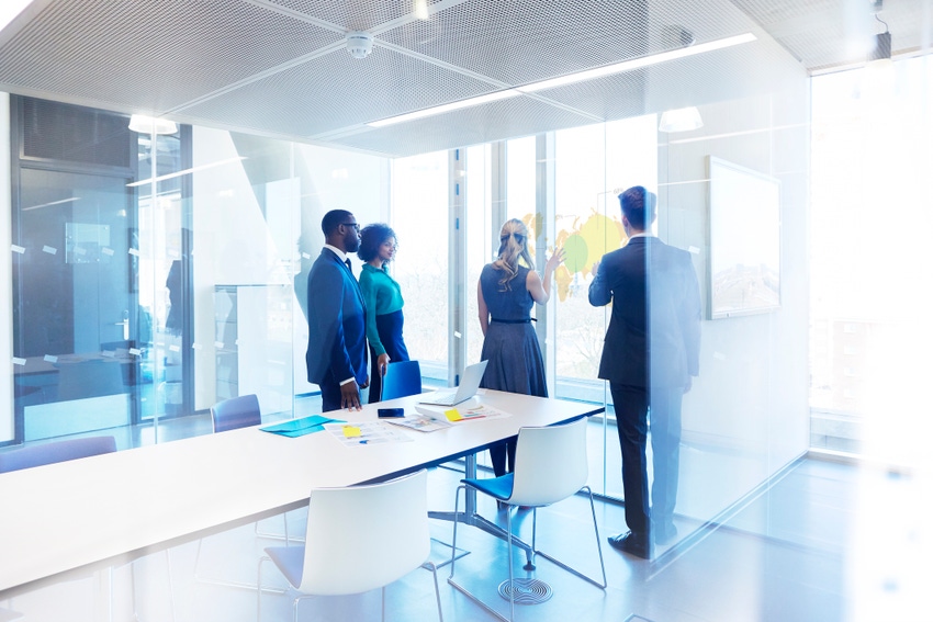 Image shows a group of business people in planning meeting