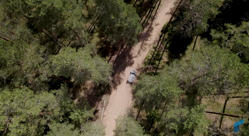 An aerial shot of autonomous military vehicles in the forest 