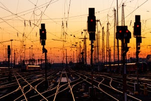 Railroad tracks at a major train station at sunset