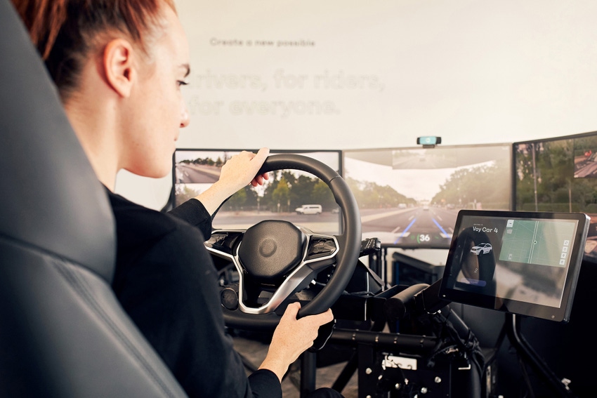 A woman "drives" a Vay vehicle remotely from one of the company's teledrive stations