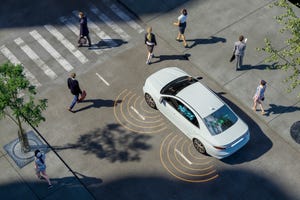 A self-driving car on a road navigating pedestrians.