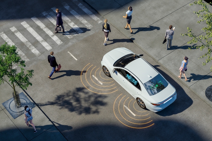 A self-driving car on a road navigating pedestrians.