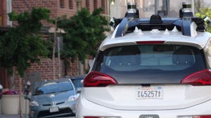 Image shows close-up view from behind of General Motors Cruise self-driving car in the South of Market (SoMA) neighborhood