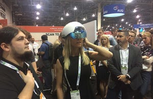 Penton regional sales account manager Emily Capaccioli tries out the DAQRI smart helmet at Autodesk University in November.