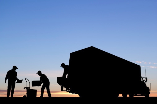 Image shows a delivery truck being unloaded.