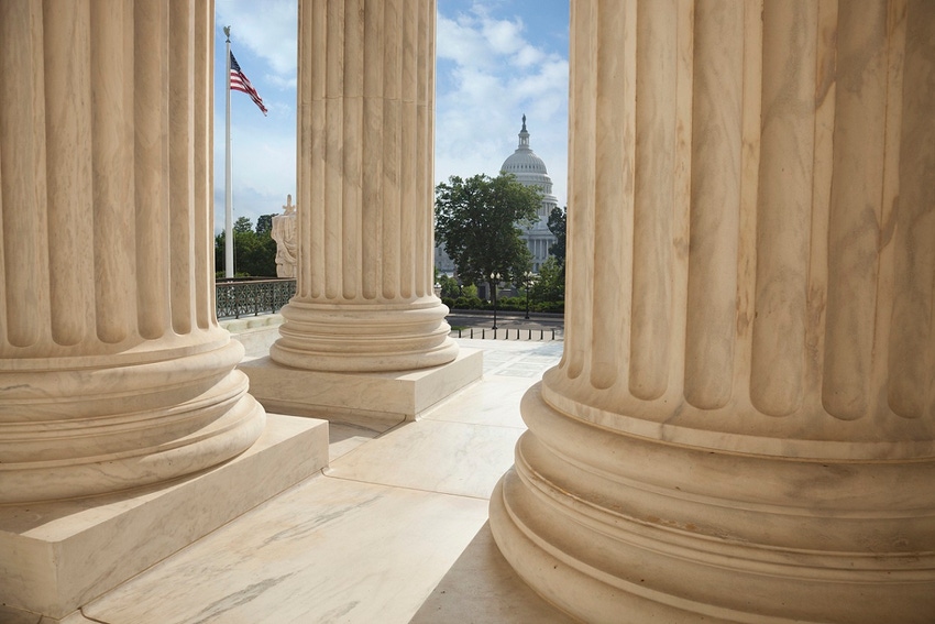 Photo of US Supreme Court columns with US Capitol in the background