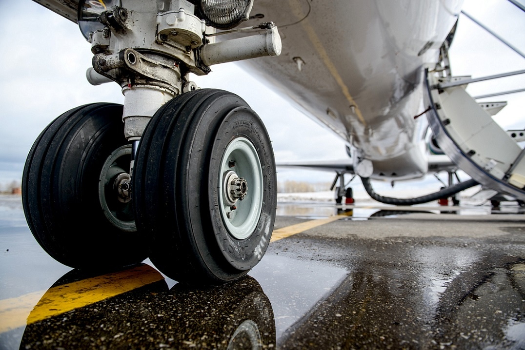 Picture of airplane landing gear on the runway Picture of airplane landing gear on the runway