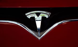 The Tesla brand logo embellishes the nose of a Tesla electric sedan in Vail, Colorado.