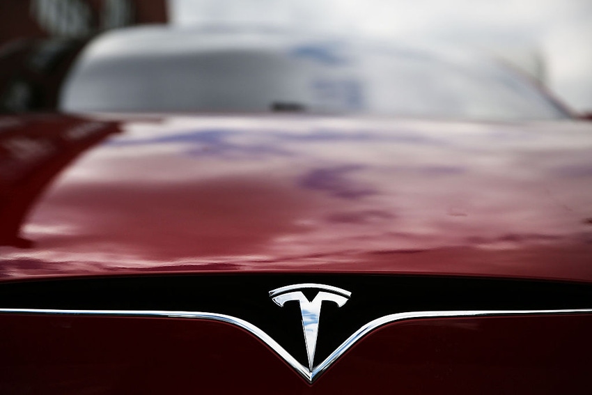 Image shows a Tesla model S sits parked outside of a new Tesla showroom and service center in Red Hook, Brooklyn