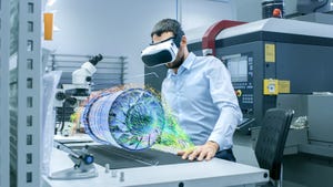 Factory Chief Engineer Wearing VR Headset Designs Engine Turbine on the Holographic Projection Table