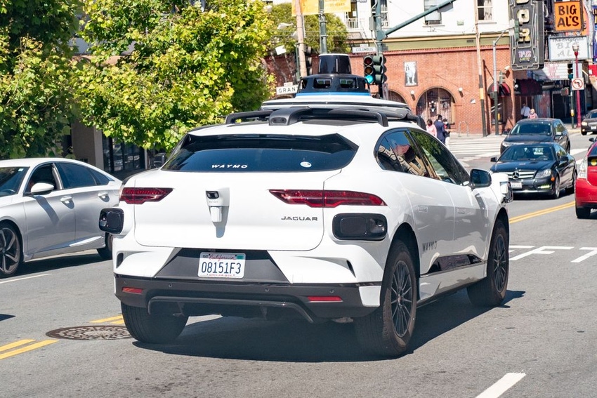 Image shows self-driving car from Waymo and Jaguar, I-Pace, driving in traffic