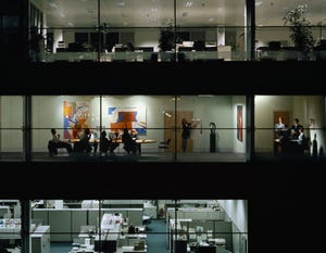 Image shows a meeting happening inside an office building.
