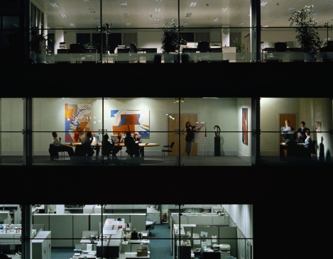 Image shows a meeting happening inside an office building. Image shows a meeting happening inside an office building.