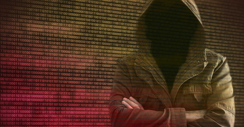 Hooded hacker against a wall of binary code