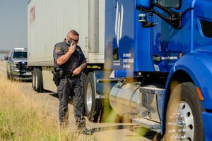 Image shows a policeman pulling over a truck